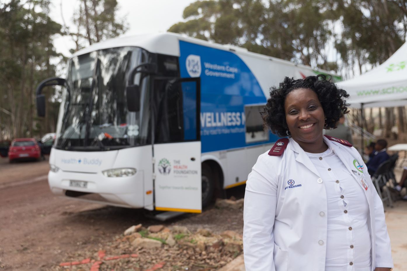 Nurse standing in front of a mobile clinic